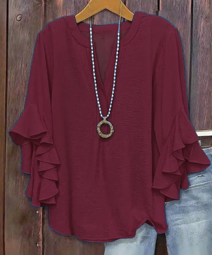 Damska bluzka z dekoltem w serek i falbanami – rozmiary plus size